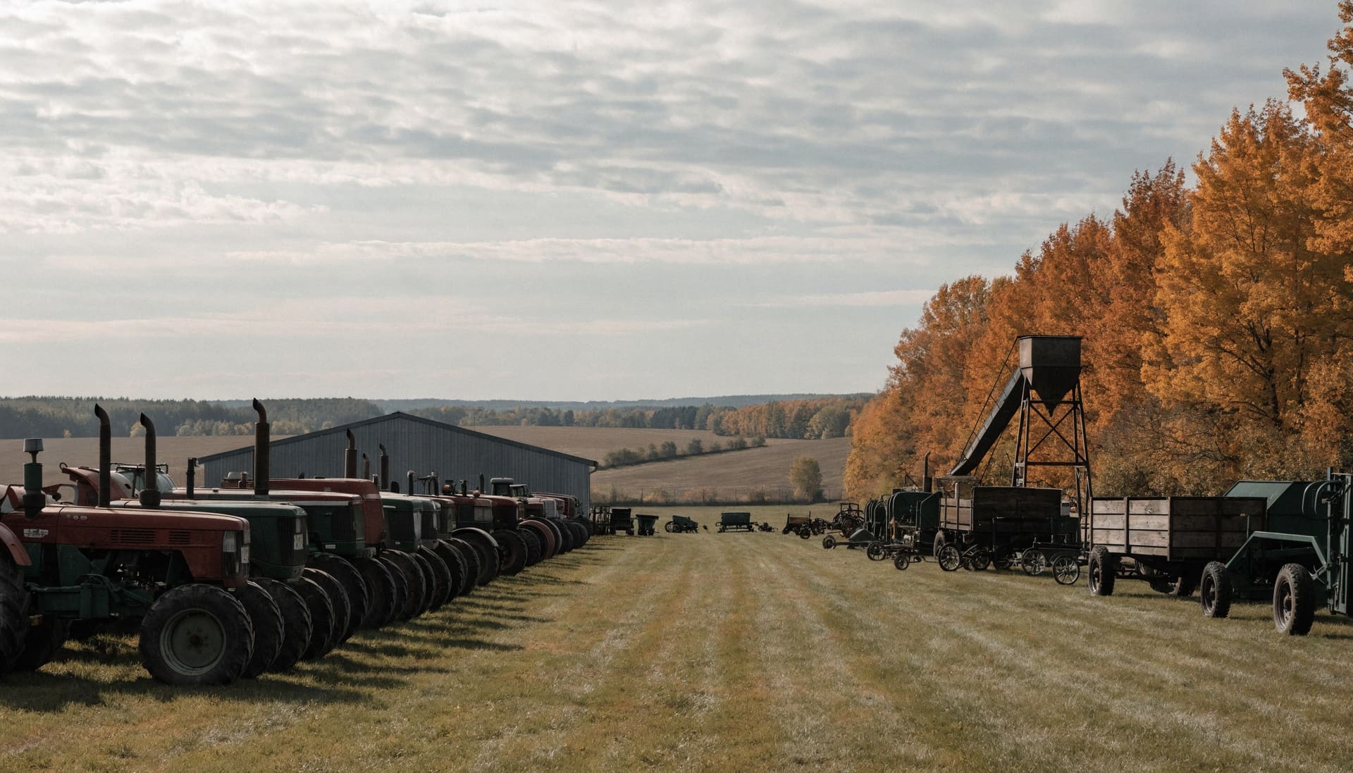Rows of tractors and farm equipment at a rural auction (representative image)