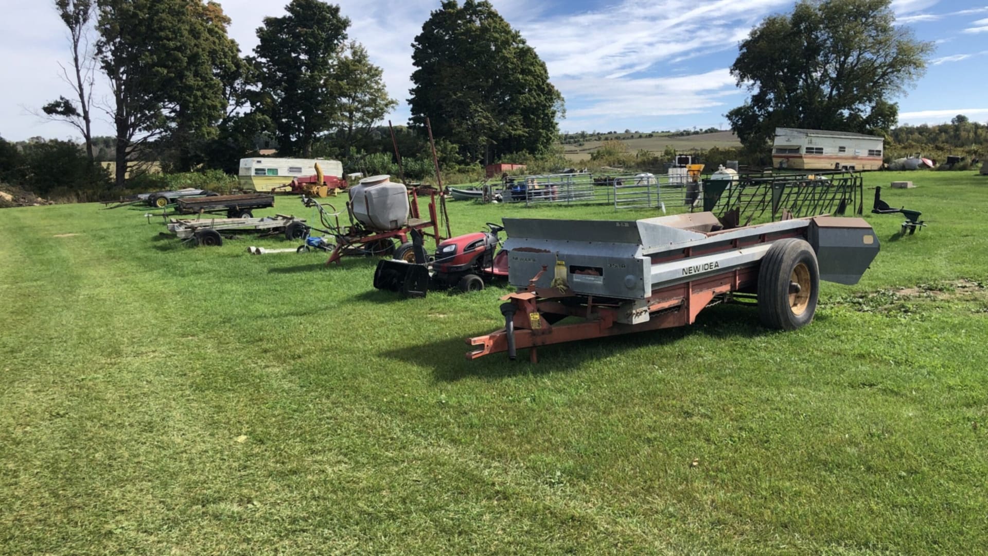 Farm equipment set out on the grass (photograph from the JMAC Auctions website)